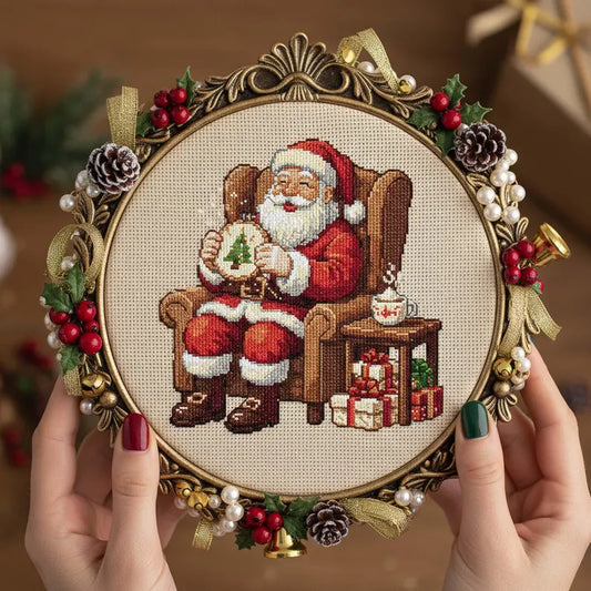 Santa Stitching Cross Stitch Pattern: Cozy Christmas Embroidery PDF with Santa Sewing a Tree and Gifts